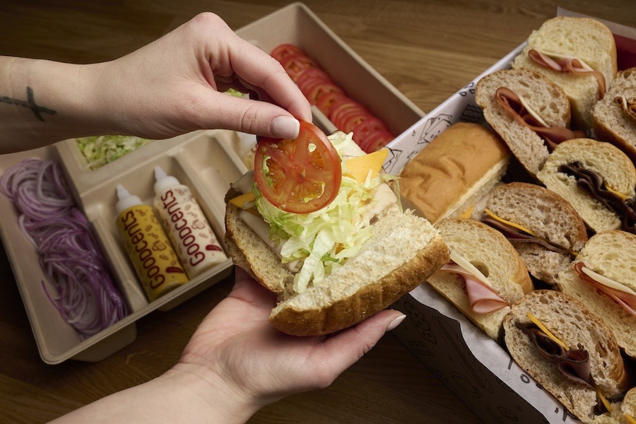 Person making a sandwich from a catering box